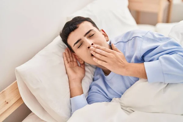 Young Non Binary Man Lying Bed Yawning — Zdjęcie stockowe