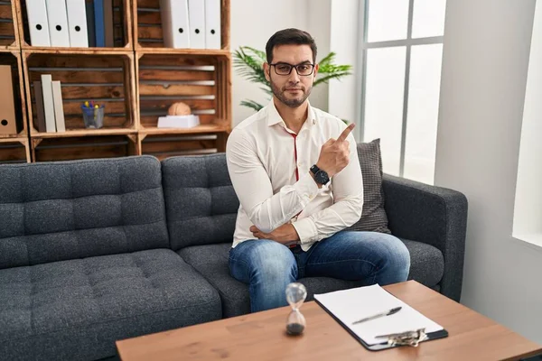 Young Hispanic Man Beard Working Consultation Office Pointing Hand Finger — Stockfoto