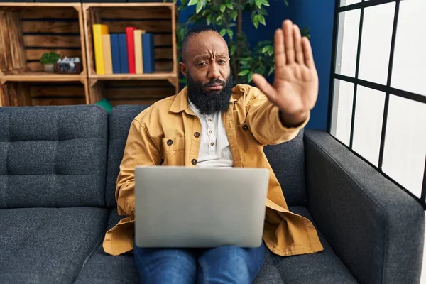 African American Man Using Laptop Home Sitting Sofa Open Hand — 스톡 사진