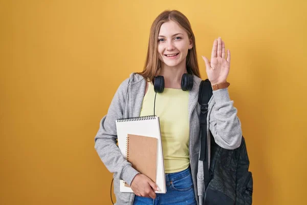 Young Caucasian Woman Wearing Student Backpack Holding Books Waiving Saying — Φωτογραφία Αρχείου