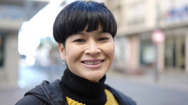 Young chinese woman smiling confident standing at street