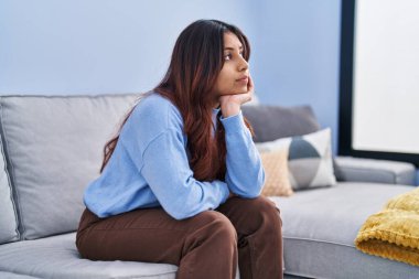 Genç İspanyol kadın evdeki kanepede otururken strese girdi.