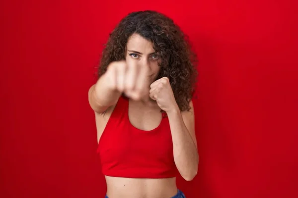 Hispanic Woman Curly Hair Standing Red Background Punching Fist Fight — Photo