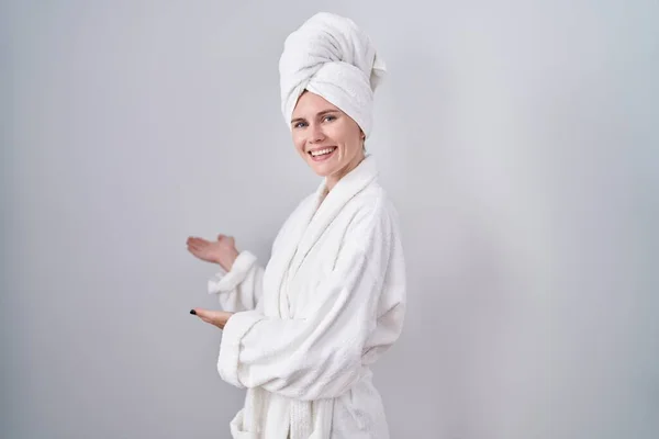 Blonde Caucasian Woman Wearing Bathrobe Inviting Enter Smiling Natural Open — Stockfoto