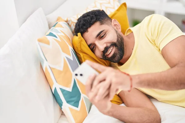 Young Arab Man Using Smartphone Lying Bed Bedroom — Fotografia de Stock