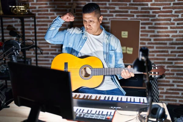Hispanic Young Man Playing Classic Guitar Music Studio Strong Person — Fotografia de Stock