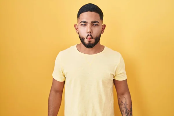 Young Hispanic Man Standing Yellow Background Making Fish Face Lips — Stock Photo, Image