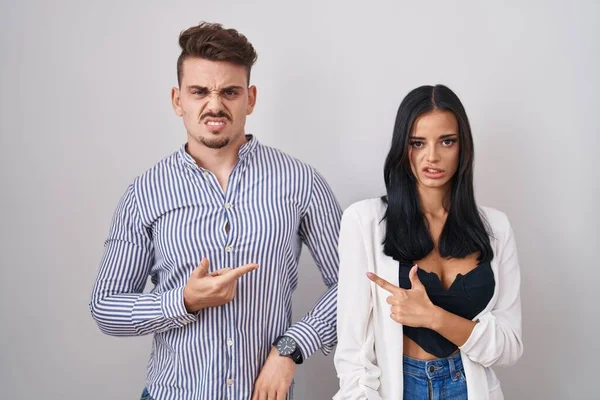 Young Hispanic Couple Standing White Background Pointing Aside Worried Nervous — Φωτογραφία Αρχείου