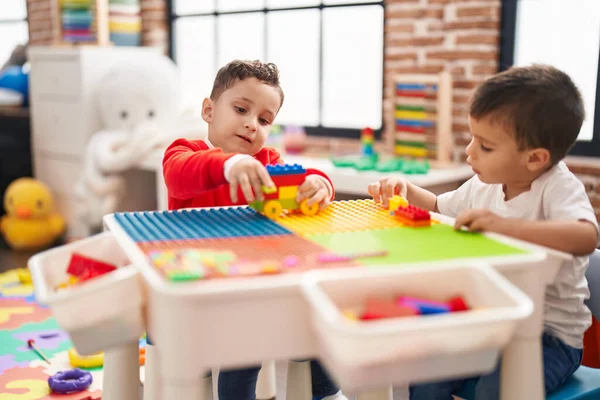 Two Kids Playing Construction Blocks Sitting Table Kindergarten — Stockfoto