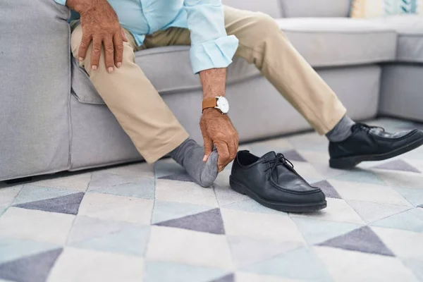 Senior Grey Haired Man Suffering Feet Pain Sitting Sofa Home — Stok fotoğraf
