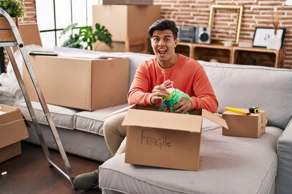 Hispanic Man Moving New Home Unpacking Celebrating Crazy Amazed Success — Foto de Stock