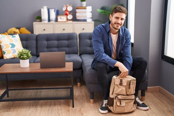 Young Caucasian Man Opening Backpack Sitting Sofa Home — Stockfoto