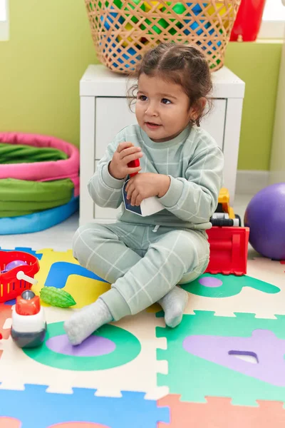 Adorable Hispanic Toddler Playing Supermarket Toy Sitting Floor Kindergarten — Stock Fotó