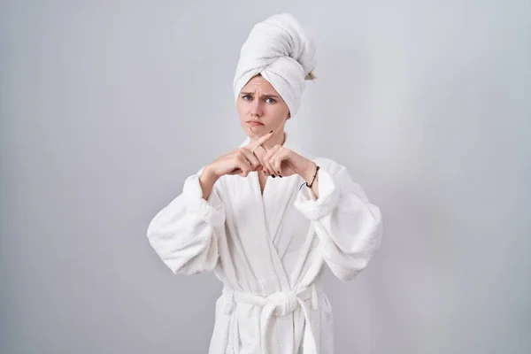 stock image Blonde caucasian woman wearing bathrobe rejection expression crossing fingers doing negative sign 