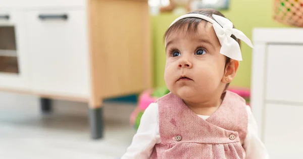 Adorable Hispanic Baby Sitting Floor Relaxed Expression Kindergarten — Stockfoto