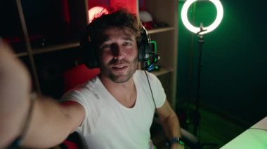 Young hispanic man streamer having video call at music studio