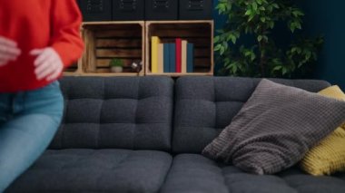 Young blonde woman lying on sofa sleeping at home