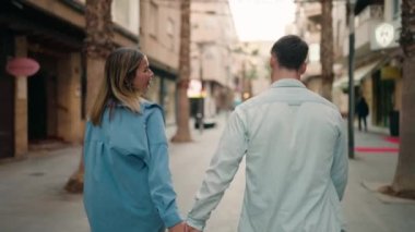 Young couple smiling confident hugging each other walking at street
