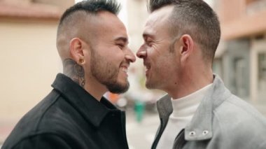 Young couple standing together kissing at street