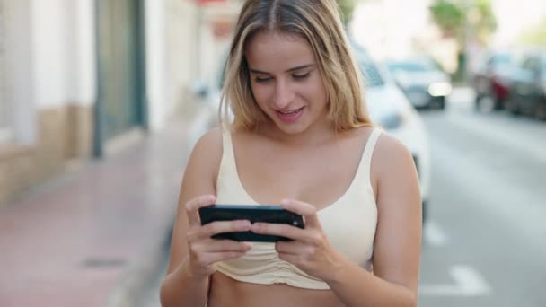 Young Blonde Woman Using Smartphone Cheerful Expression Street — Stock Video