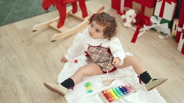 Adorable Hispanic Girl Playing Xylophone Sitting Floor Christmas Tree Home — Stock video