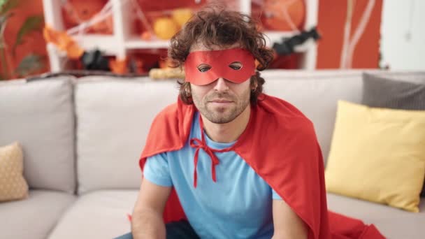 Young Hispanic Man Wearing Superhero Costume Having Halloween Party Home — Stockvideo