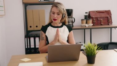 Young beautiful hispanic woman call center agent having video call at office