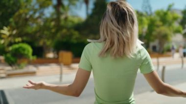 beautiful blonde young woman with long hair feeling happy at city street