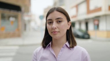 portrait of a young beautiful woman standing at city street