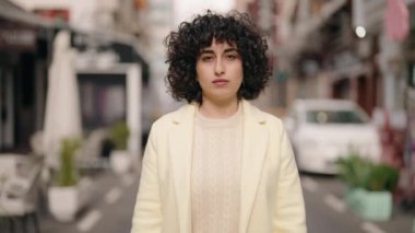 Sokakta kendinden emin gülümseyen genç bir kadın