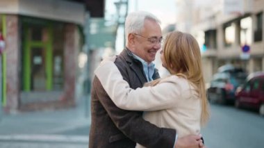 Middle age couple couple smiling confident dancing at street