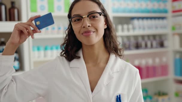 若いアフリカ系アメリカ人女性薬剤師笑顔自信を持って保持クレジットカードで薬局 — ストック動画