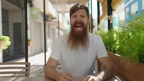 Young Redhead Man Smiling Confident Sitting Table Coffee Shop Terrace — Stok video
