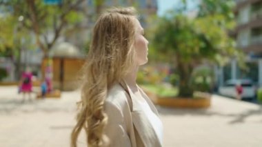 Young caucasian woman smiling at park