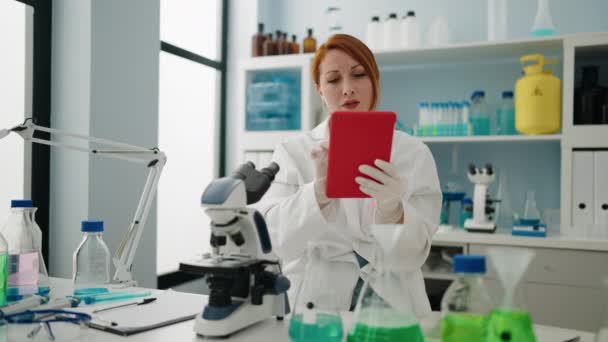 Young Redhead Woman Wearing Scientist Uniform Using Touchpad Laboratory — Stock video