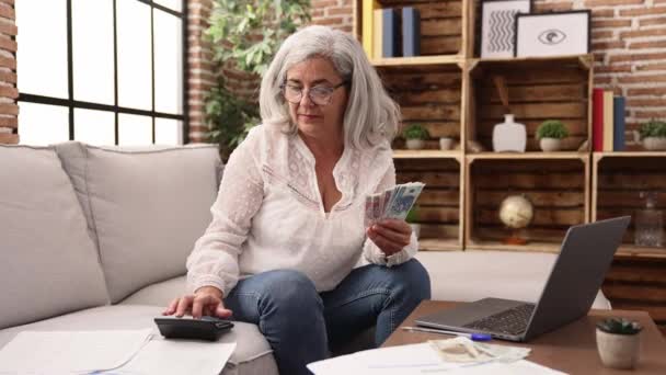 Middle Age Grey Haired Woman Doing Accounting Using Laptop Calculator — Stock video
