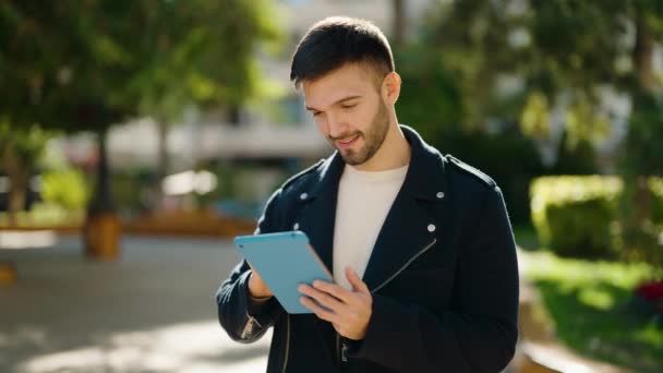 Young Hispanic Man Smiling Confident Using Touchpad Park — Wideo stockowe
