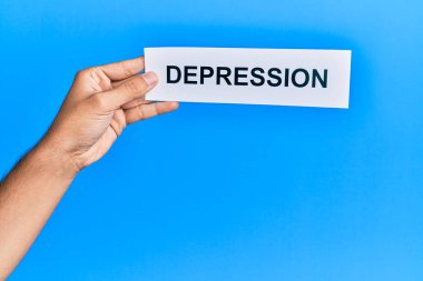 Hand of caucasian man holding paper with depression word over isolated blue background