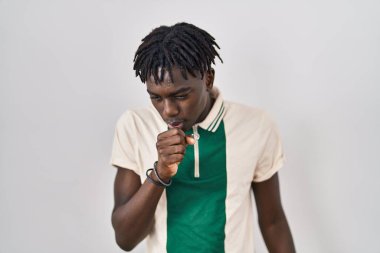 African man with dreadlocks standing over isolated background feeling unwell and coughing as symptom for cold or bronchitis. health care concept. 