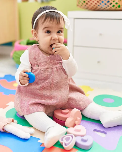 Adorable Hispanic Baby Sitting Floor Sucking Toy Kindergarten — Stock Photo, Image