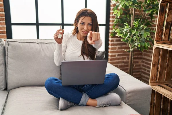 Young Brunette Woman Using Laptop Holding Keys New Home Pointing — Stock Photo, Image