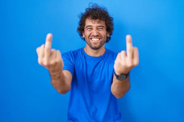 Hispanic Young Man Standing Blue Background Showing Middle Finger Doing — Zdjęcie stockowe