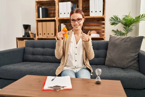 Young Caucasian Woman Holding Awareness Orange Ribbon Office Smiling Happy — Stock Photo, Image
