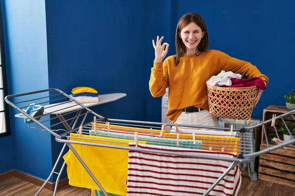 Young Brunette Woman Hanging Clothes Clothesline Doing Sign Fingers Smiling — Stockfoto