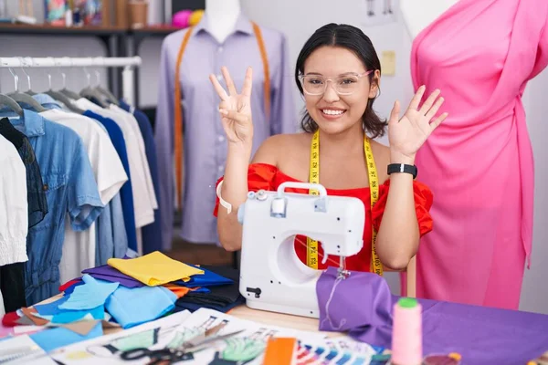 Hispanic Young Woman Dressmaker Designer Using Sewing Machine Showing Pointing — Stock Photo, Image
