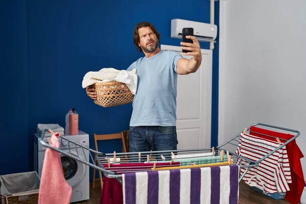 Handsome Middle Age Man Holding Laundry Basket Doing Selfie Picture — Fotografia de Stock