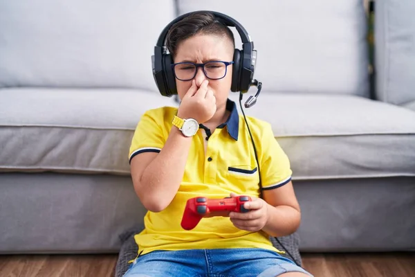 Young Hispanic Kid Playing Video Game Holding Controller Wearing Headphones — Zdjęcie stockowe