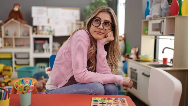 Young Blonde Woman Teacher Sitting Table Doubt Expression Kindergarten —  Fotos de Stock