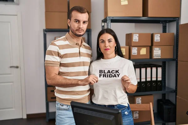 Young Couple Working Small Business Holding Black Friday Banner Relaxed — Fotografia de Stock