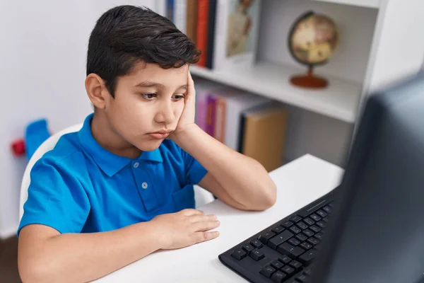 Adorable Hispanic Boy Student Using Computer Tired Expression Classroom — Stockfoto